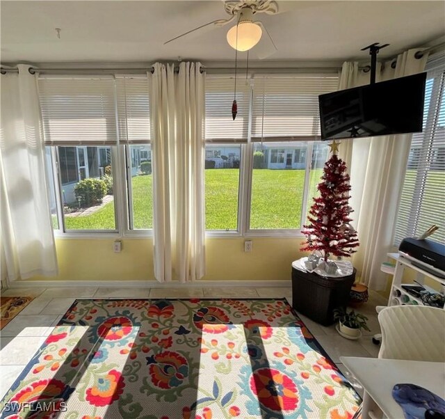 sunroom / solarium featuring ceiling fan