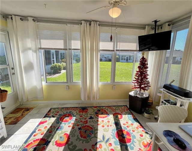 sunroom / solarium featuring ceiling fan and a healthy amount of sunlight