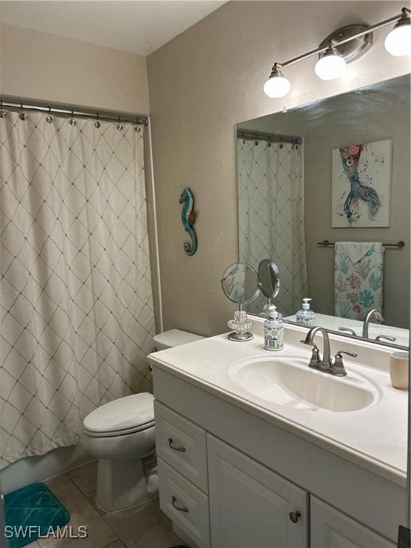 bathroom featuring toilet, curtained shower, tile patterned flooring, and vanity