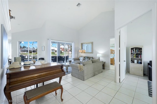 living room featuring light tile patterned floors and high vaulted ceiling