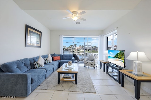 living room with ceiling fan and light tile patterned floors