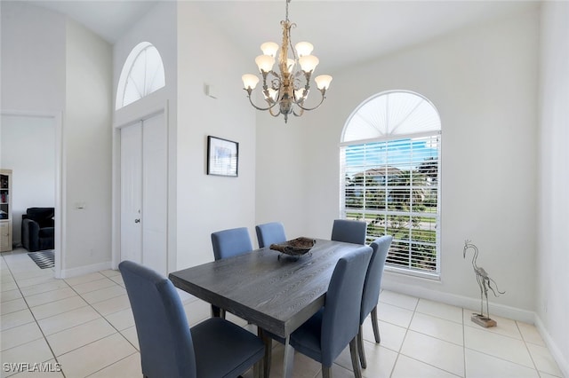 dining area with light tile patterned floors and a chandelier