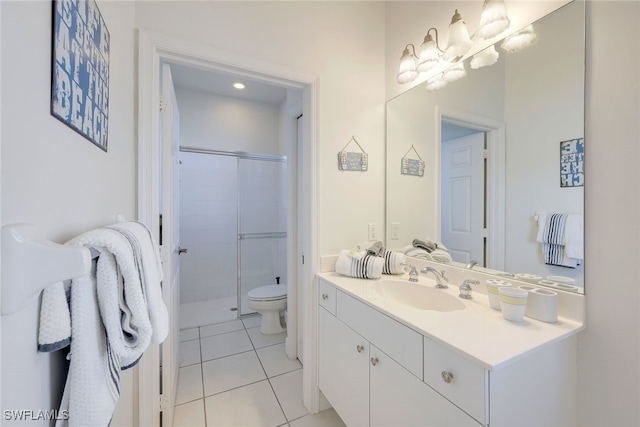 bathroom with tile patterned floors, vanity, toilet, and a shower with shower door