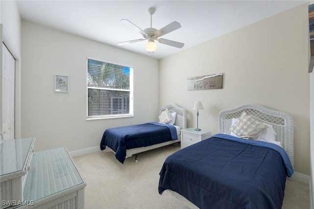 bedroom featuring ceiling fan, a closet, and light colored carpet