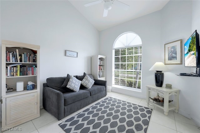 living room featuring ceiling fan, light tile patterned flooring, and lofted ceiling