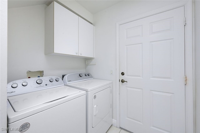 washroom featuring washing machine and dryer and cabinets