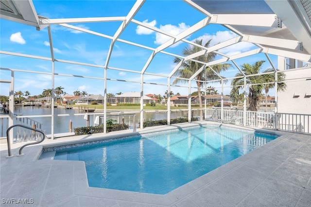 view of swimming pool featuring glass enclosure, a water view, and a patio