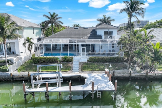 back of property featuring a water view and a lanai