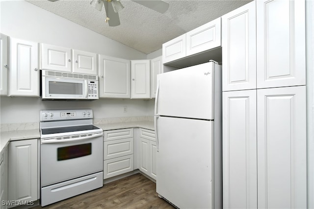 kitchen with dark hardwood / wood-style flooring, vaulted ceiling, a textured ceiling, white appliances, and white cabinets