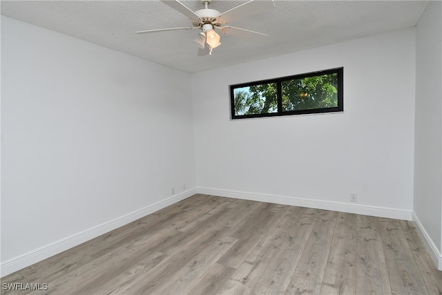 spare room featuring ceiling fan, a textured ceiling, and light hardwood / wood-style flooring