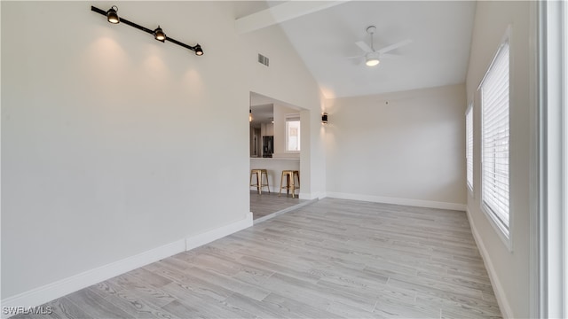 empty room with high vaulted ceiling, ceiling fan, light hardwood / wood-style floors, and beamed ceiling