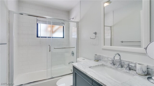 930 SW 28th St, Cape Coral, FL 33914 - bathroom with toilet, vanity, and enclosed tub / shower combo
