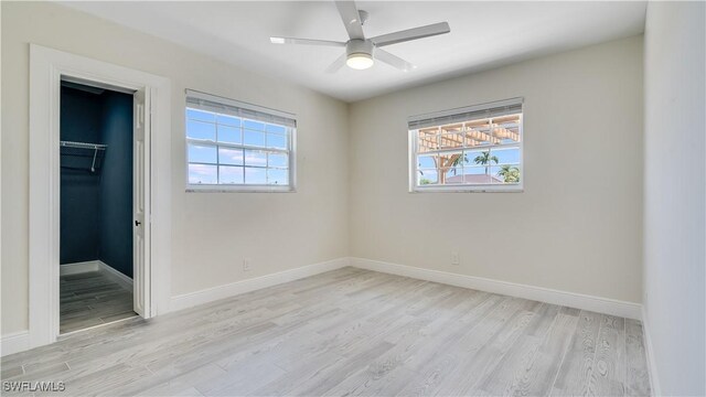 930 SW 28th St, Cape Coral, FL 33914 - unfurnished bedroom with light wood-style flooring, multiple windows, and baseboards