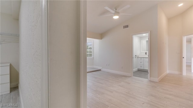 930 SW 28th St, Cape Coral, FL 33914 - unfurnished room with vaulted ceiling, a ceiling fan, light wood-style flooring, and baseboards