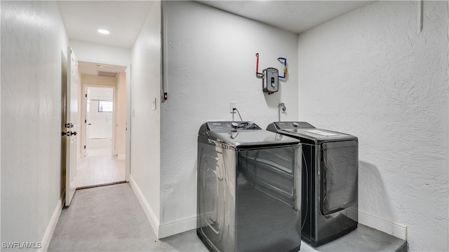 laundry room featuring washing machine and clothes dryer