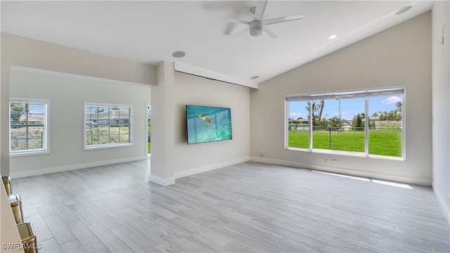 unfurnished living room with ceiling fan, a healthy amount of sunlight, light wood-type flooring, and lofted ceiling