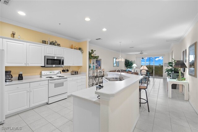 kitchen featuring white cabinetry, sink, an island with sink, white appliances, and crown molding