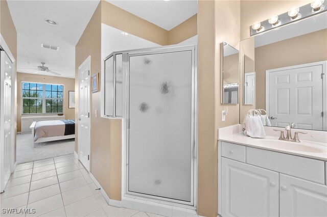 bathroom featuring vanity, an enclosed shower, tile patterned flooring, and ceiling fan