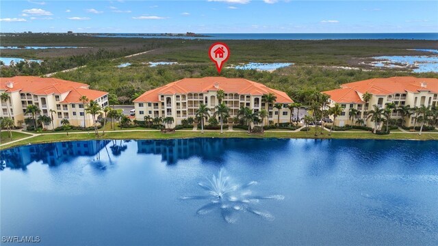 birds eye view of property with a water view