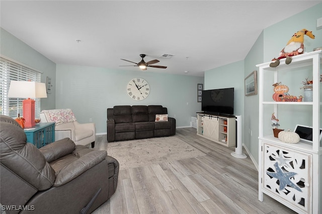 living room with ceiling fan and light hardwood / wood-style floors