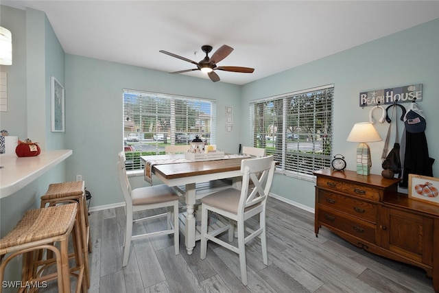 dining room with light hardwood / wood-style floors and ceiling fan