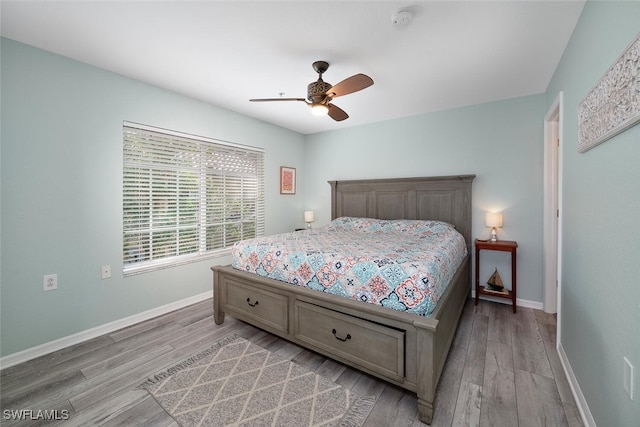 bedroom with ceiling fan and light hardwood / wood-style floors