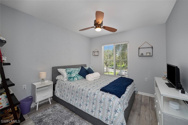 bedroom with ceiling fan and hardwood / wood-style flooring