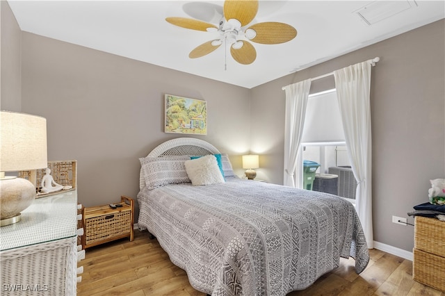 bedroom with ceiling fan and light hardwood / wood-style floors