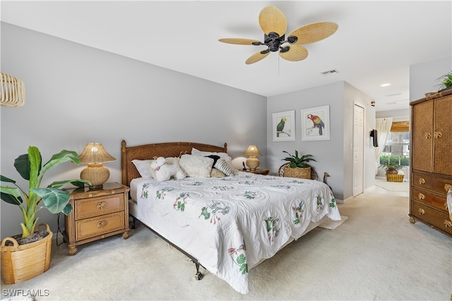 carpeted bedroom featuring ceiling fan and a closet