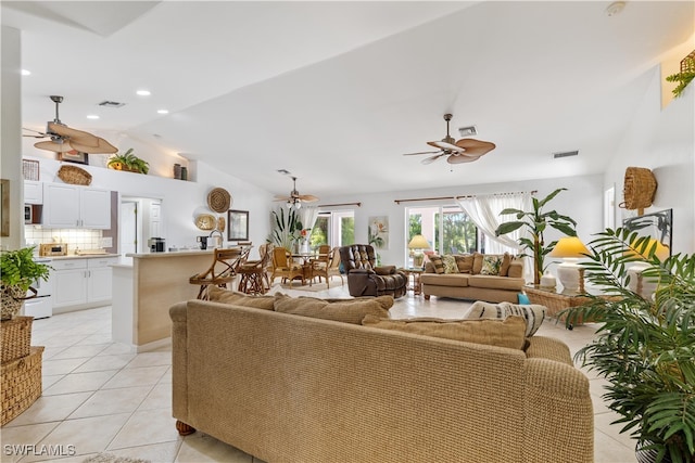 tiled living room featuring ceiling fan and vaulted ceiling