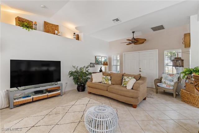 living room featuring ceiling fan, light tile patterned floors, and high vaulted ceiling