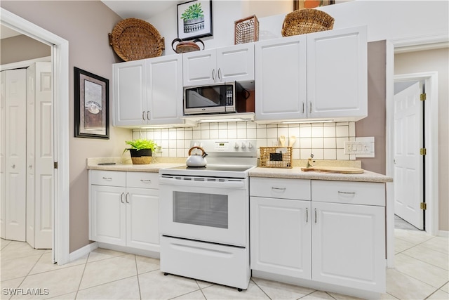 kitchen featuring white cabinetry and white electric range