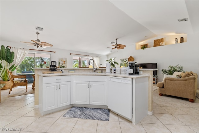 kitchen with white cabinetry, dishwasher, sink, vaulted ceiling, and light tile patterned floors