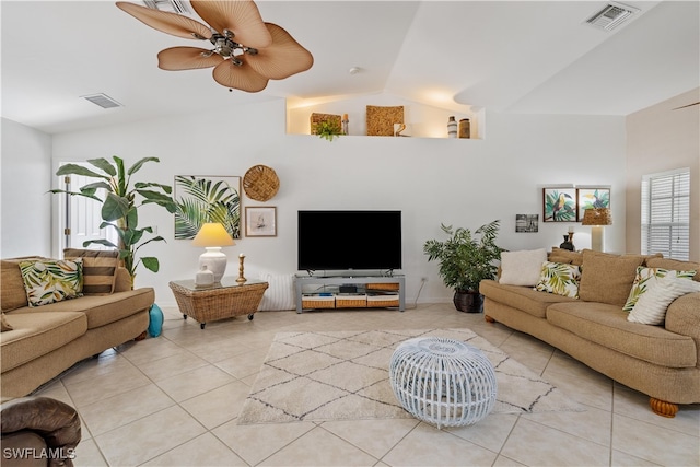 tiled living room featuring ceiling fan and vaulted ceiling