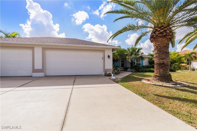 view of front of home featuring a front yard and a garage