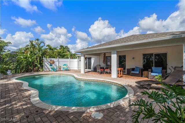 view of swimming pool with an outdoor living space and a patio area