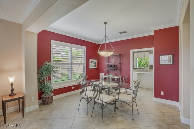 dining room featuring light tile patterned floors and ornamental molding