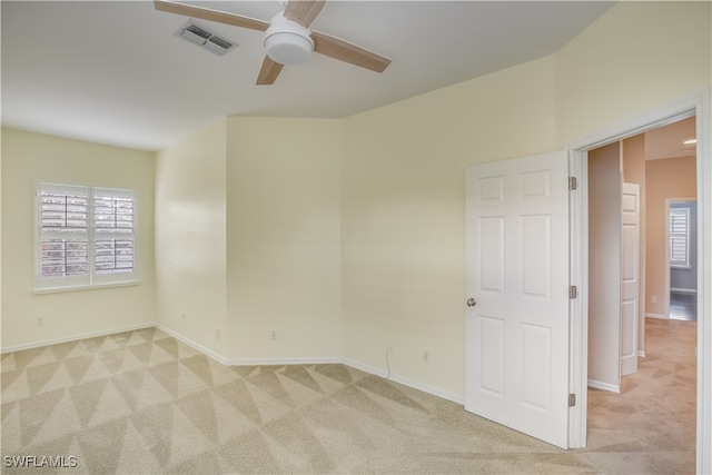 carpeted empty room featuring ceiling fan