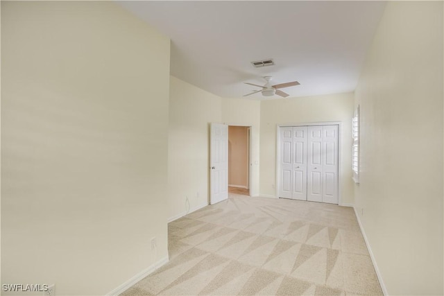 22890 Forest Ridge Dr, Estero, FL 33928 - unfurnished bedroom featuring baseboards, light colored carpet, a closet, and a ceiling fan