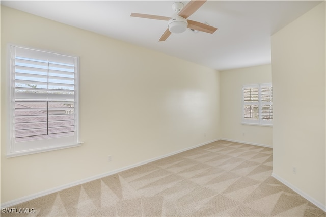 unfurnished room with light carpet, plenty of natural light, and ceiling fan