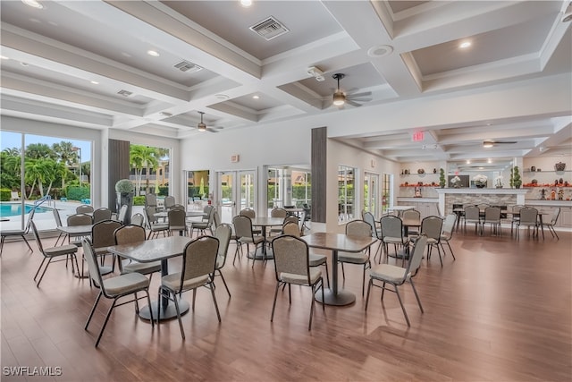 dining area featuring beamed ceiling, hardwood / wood-style floors, and ceiling fan