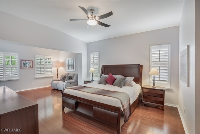 bedroom featuring ceiling fan, light wood-type flooring, and lofted ceiling