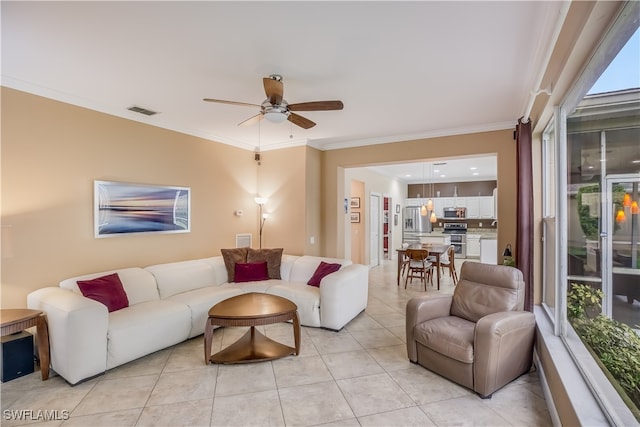 tiled living room featuring ceiling fan, crown molding, and a wealth of natural light