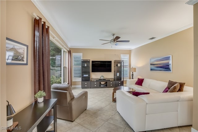 tiled living room featuring ceiling fan and crown molding