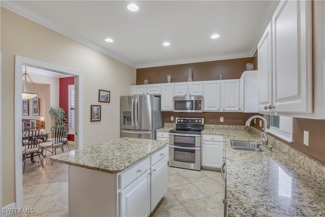 22890 Forest Ridge Dr, Estero, FL 33928 - kitchen with appliances with stainless steel finishes, a sink, crown molding, a center island, and white cabinetry