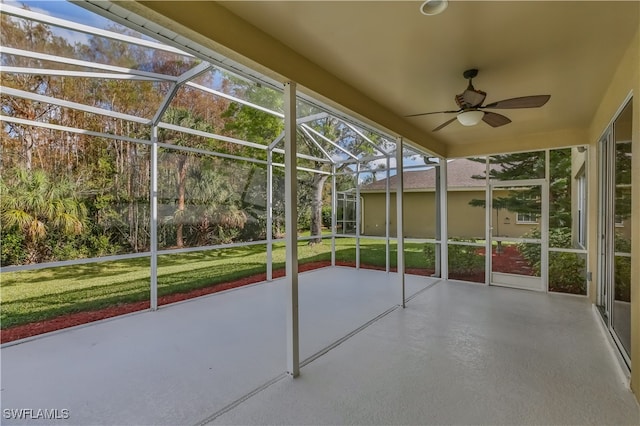 unfurnished sunroom featuring ceiling fan