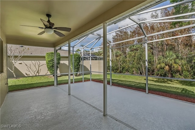 unfurnished sunroom with ceiling fan