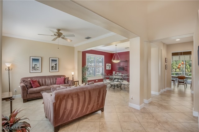 tiled living room with ceiling fan and ornamental molding