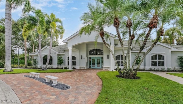 22890 Forest Ridge Dr, Estero, FL 33928 - back of property with french doors, stucco siding, and a lawn