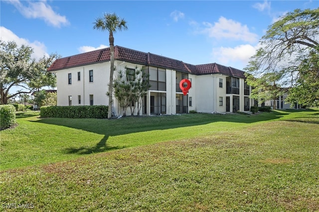 back of house with a lawn